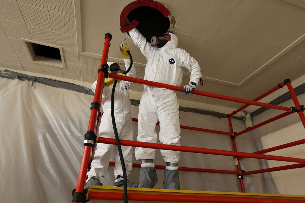 asbestos removal workers in hazmat suits