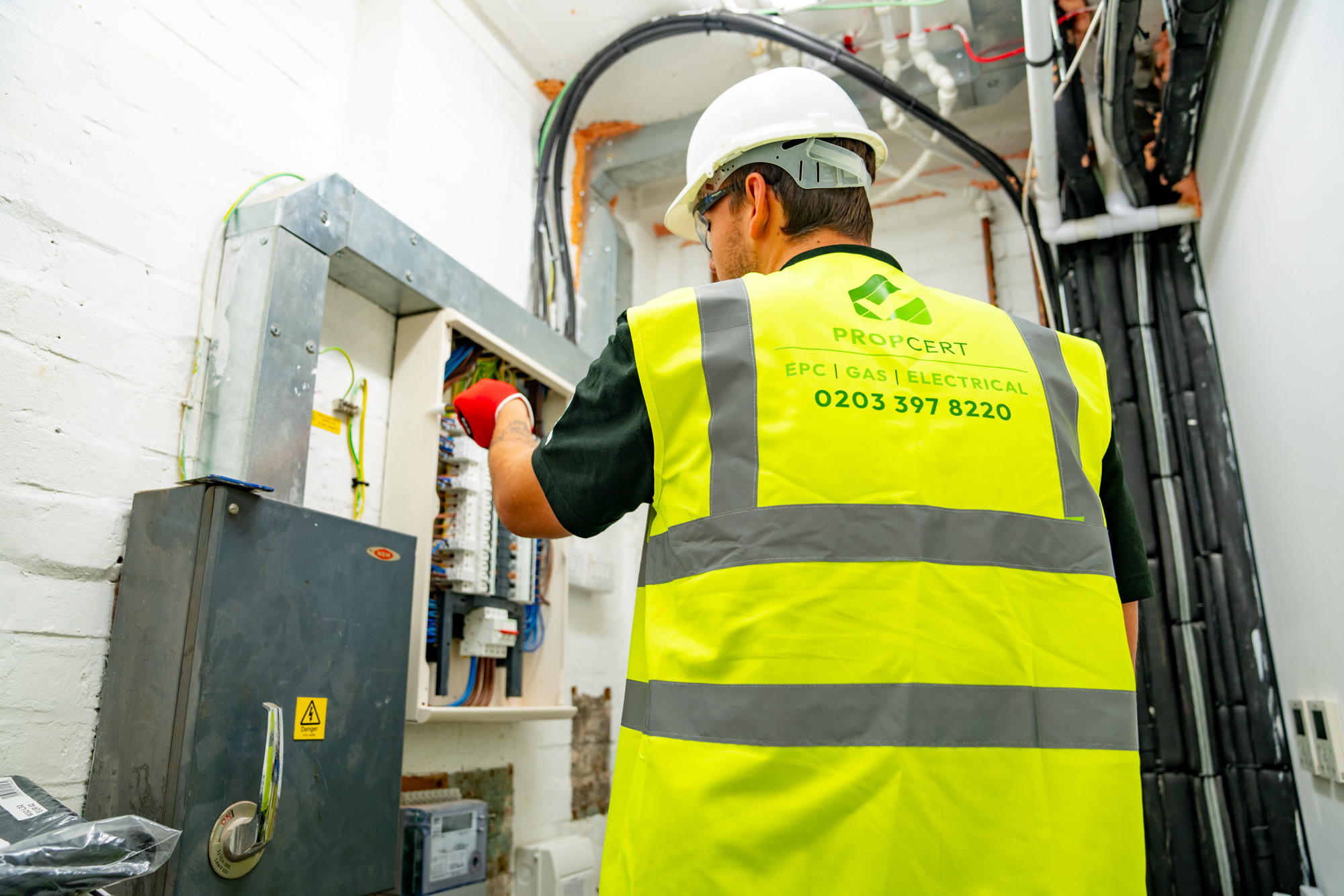 electrician checking fuse board