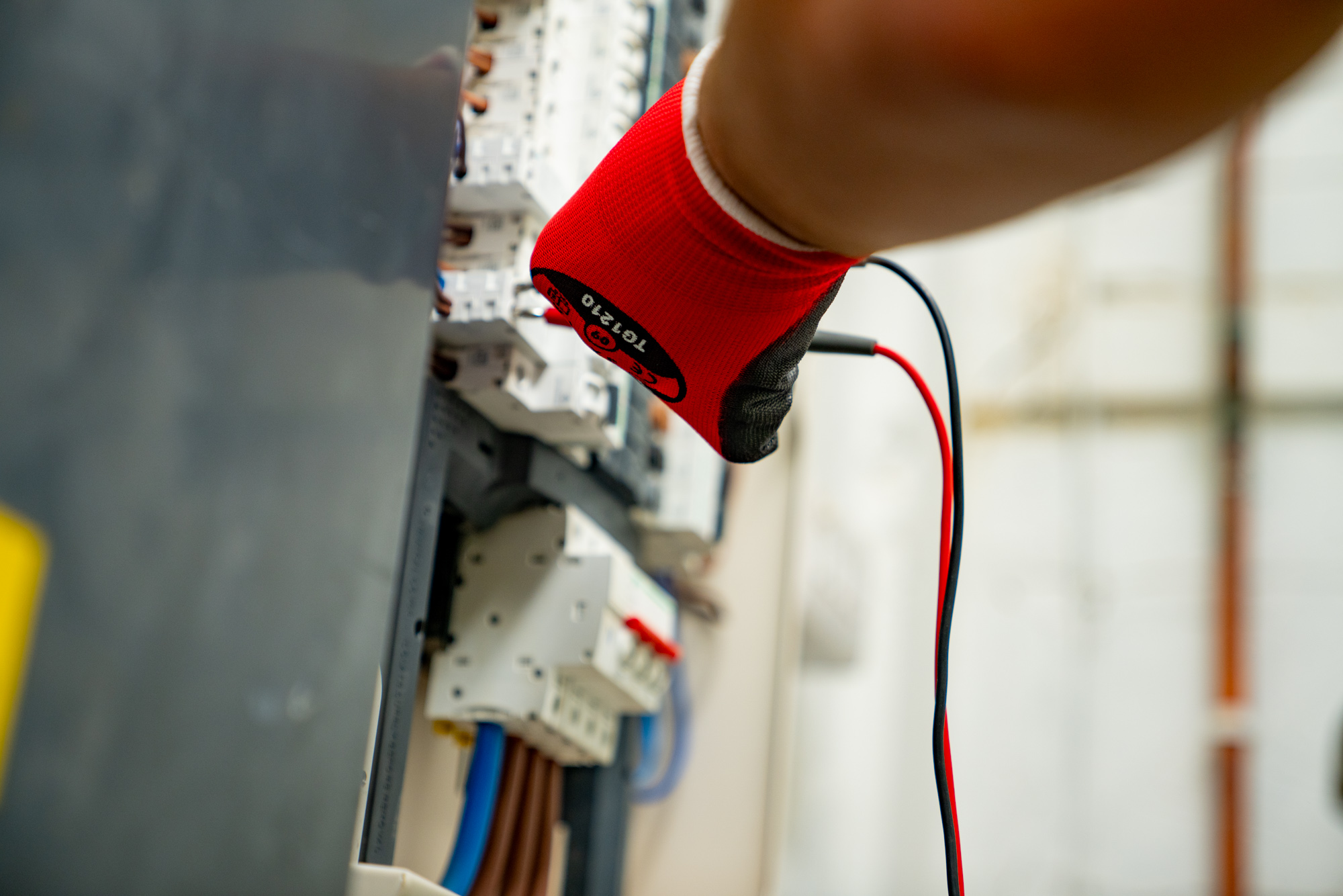 electrician testing circuits and fuses with a multimeter