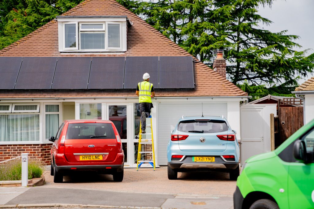 engineer on ladder installing solar panels