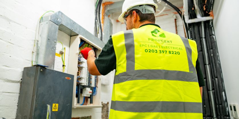 electrician checking fuse board