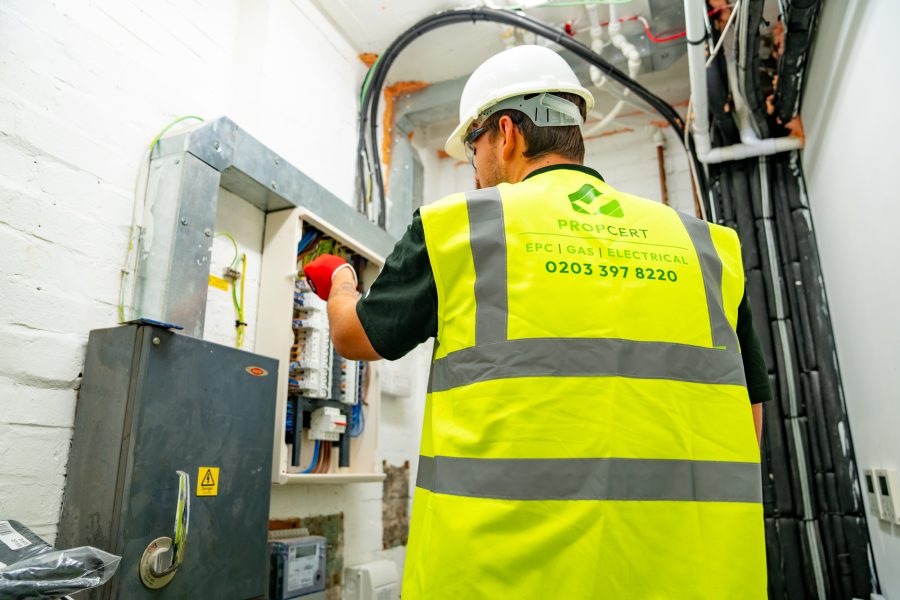 electrician checking fuse board