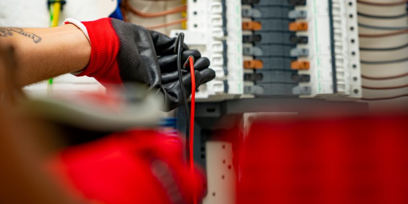 electrician checking fuseboard