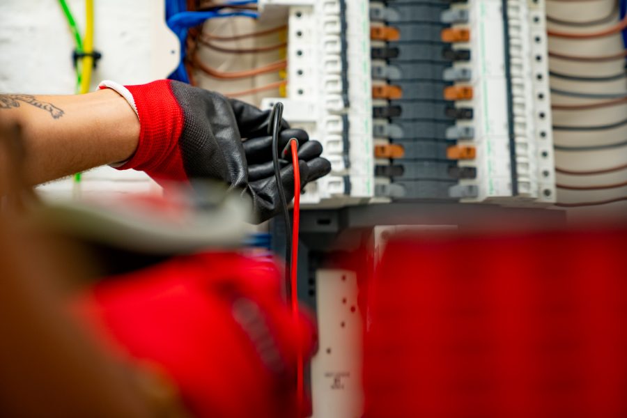 electrician checking fuseboard
