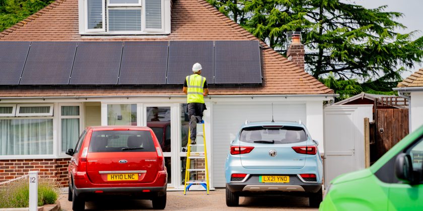 engineer on ladder installing solar panels